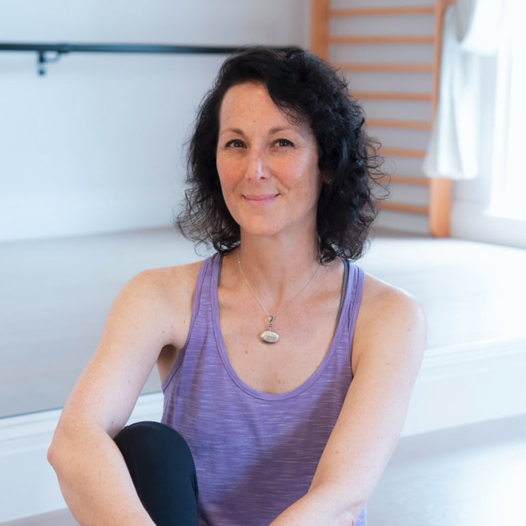 Samantha Flower sitting in a Pilates studio