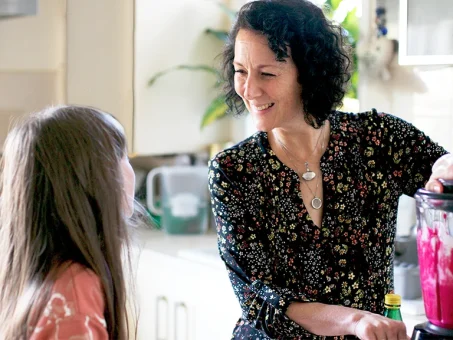 Samantha Flower in her kitchen, blending a fruit smoothie